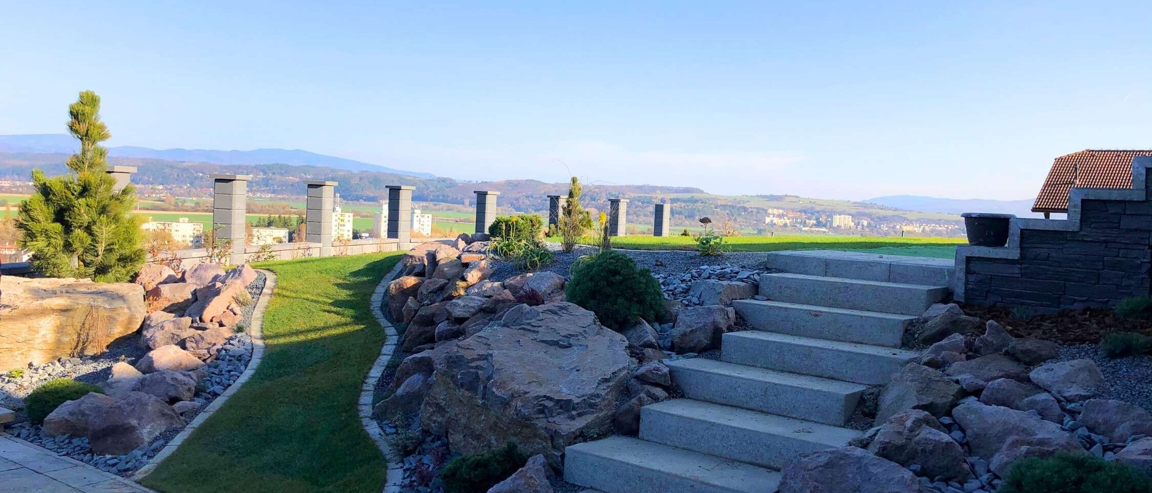 Garden rock garden with ornamental stones and flowering plants