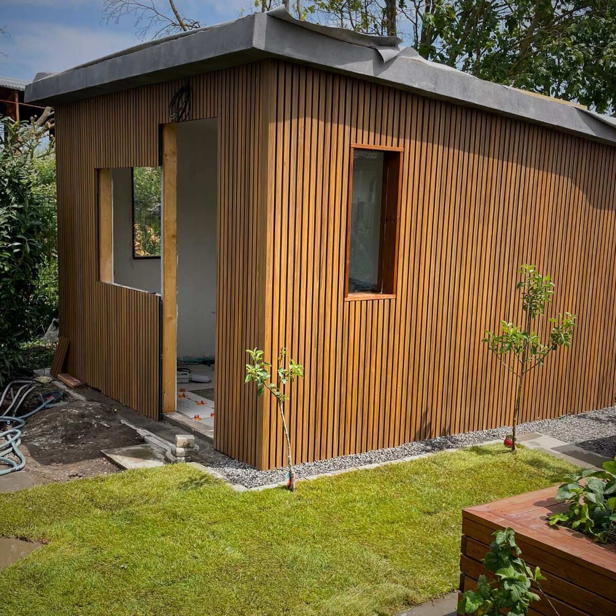 Realization of a garden house - assembly of a wooden structure in the garden for storing tools and relaxing by Dream Garden
