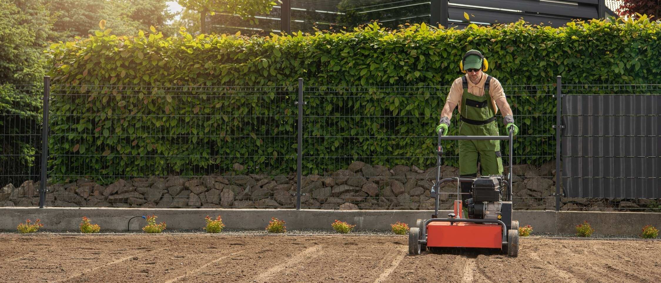 Preparing the soil for new turf – removing weeds, loosening, levelling and fertilising before sowing