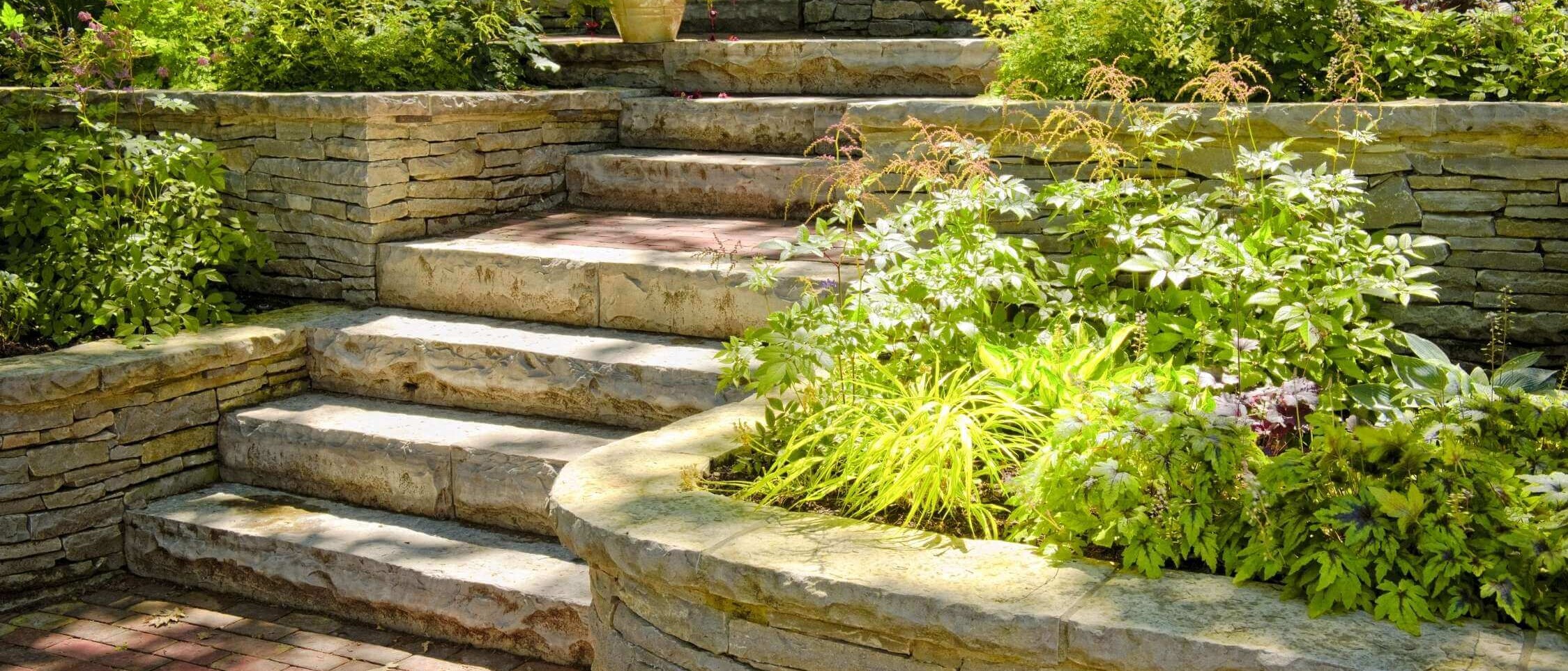 Garden steps made of natural stone in a landscaped garden